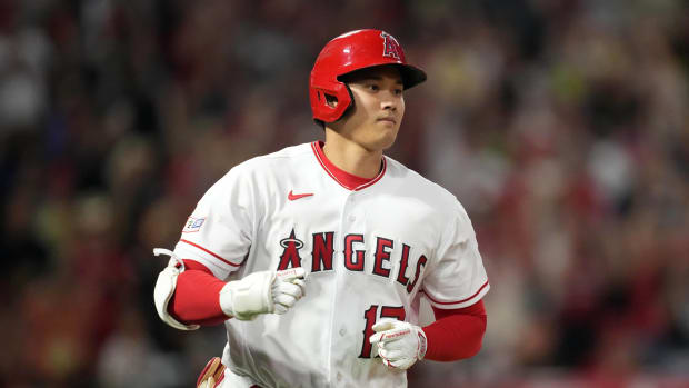 Angels star Shohei Ohtani rounds the bases after hitting a home run in a game.